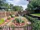 Serene backyard garden featuring a stone pathway and a variety of plants and flowers at 12739 W Alabama Pl, Lakewood, CO 80228