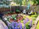 Landscaped backyard garden with sitting area and beautiful flowers at 12739 W Alabama Pl, Lakewood, CO 80228