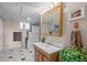 Bathroom with tile flooring, bathtub, and a wooden vanity and mirror at 12739 W Alabama Pl, Lakewood, CO 80228