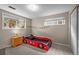Fun themed bedroom featuring a car bed, neutral walls, and a bright window at 12739 W Alabama Pl, Lakewood, CO 80228