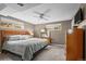 Cozy bedroom with a large bed, ceiling fan, and natural light from multiple windows at 12739 W Alabama Pl, Lakewood, CO 80228