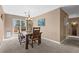 Inviting dining area with a modern light fixture, table and chairs, and access to the outdoors at 12739 W Alabama Pl, Lakewood, CO 80228