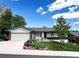 Charming single-story home with a manicured lawn, beautiful landscaping, and a cozy front porch seating area at 12739 W Alabama Pl, Lakewood, CO 80228
