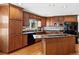 Well-appointed kitchen with custom wood cabinets, granite countertops, and modern appliances at 12739 W Alabama Pl, Lakewood, CO 80228