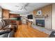 Spacious living room with a brick fireplace and view into the adjacent kitchen at 12739 W Alabama Pl, Lakewood, CO 80228