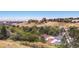 Panoramic city view with residential homes and lush greenery, featuring downtown in the distance at 16259 W 10Th Ave # K1, Golden, CO 80401