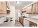Functional kitchen featuring light wood cabinets, neutral countertops and white appliances at 16259 W 10Th Ave # K1, Golden, CO 80401