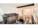 Open concept living room featuring exposed ceiling beam and comfortable seating at 16259 W 10Th Ave # K1, Golden, CO 80401