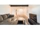 Cozy living room featuring exposed ceiling beam, neutral walls, and comfortable seating at 16259 W 10Th Ave # K1, Golden, CO 80401