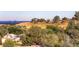 Elevated neighborhood view showcasing homes nestled among mature trees and rolling hills under a sunny sky at 16259 W 10Th Ave # K1, Golden, CO 80401