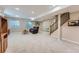 The finished basement has newer carpet, lots of room for activities, and access to the stairs at 2417 S Racine Way, Aurora, CO 80014