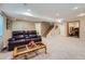 Finished basement features plush carpeting, large seating area, and access to downstairs office space at 2417 S Racine Way, Aurora, CO 80014
