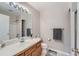 Neutral bathroom with modern vanity, large mirror, and tiled floor at 2417 S Racine Way, Aurora, CO 80014