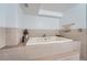 Clean tiled bathroom features a large tiled tub perfect for relaxing after a long day at 2417 S Racine Way, Aurora, CO 80014