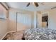 Bedroom with carpet, window with blinds, closet and doorway at 2417 S Racine Way, Aurora, CO 80014