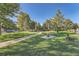 Enjoy the community park's walking paths and relaxing benches under mature trees at 2417 S Racine Way, Aurora, CO 80014