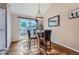 Cozy dining area with a modern table, chairs, and natural light from sliding glass doors at 2417 S Racine Way, Aurora, CO 80014