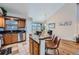Modern kitchen with granite countertops, stainless steel appliances, and bar seating, adjacent to a dining area at 2417 S Racine Way, Aurora, CO 80014