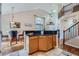 Bright kitchen with an island and bar seating, adjacent to a dining area with a view of the living room at 2417 S Racine Way, Aurora, CO 80014