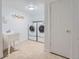 Functional laundry room with modern washer and dryer, utility sink, and tile flooring at 2417 S Racine Way, Aurora, CO 80014