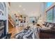 Open floor plan with hardwood floors, featuring a living room, kitchen with bar seating, and dining area at 2417 S Racine Way, Aurora, CO 80014
