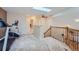 Spacious loft area features a skylight, ceiling fan, exercise equipment, and access to bathroom and stairs at 2417 S Racine Way, Aurora, CO 80014