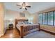 Spacious bedroom featuring a ceiling fan, warm colors, and wood-look floors at 2417 S Racine Way, Aurora, CO 80014