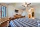Bedroom featuring vaulted ceiling, ceiling fan, and ensuite bathroom with walk-in closet at 2417 S Racine Way, Aurora, CO 80014