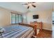 Well-lit bedroom with ceiling fan and spacious windows offering natural light at 2417 S Racine Way, Aurora, CO 80014