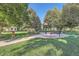 Relaxing outdoor space featuring a park bench, Little Free Library, lush greenery, and walking paths at 2417 S Racine Way, Aurora, CO 80014