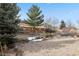 Large backyard with patio and a wooden fence at 7139 Pine Hills Way, Littleton, CO 80125