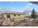 Landscaped backyard with patio and mature trees at 7139 Pine Hills Way, Littleton, CO 80125