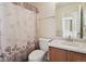 Bathroom with shower/tub combo and wood vanity at 7139 Pine Hills Way, Littleton, CO 80125