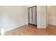Simple bedroom featuring hardwood floors and ample closet space at 7139 Pine Hills Way, Littleton, CO 80125