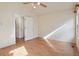 Bright bedroom with hardwood floors and access to hallway bathroom at 7139 Pine Hills Way, Littleton, CO 80125