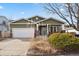 House exterior with landscaping and driveway at 7139 Pine Hills Way, Littleton, CO 80125