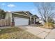 Front view of house with driveway and landscaping at 7139 Pine Hills Way, Littleton, CO 80125