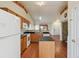 Eat-in kitchen with wood cabinets, granite countertops, and island at 7139 Pine Hills Way, Littleton, CO 80125
