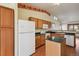 Kitchen with wood cabinets, granite countertop and island at 7139 Pine Hills Way, Littleton, CO 80125