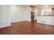 Living room with hardwood floors, laundry and kitchen access at 7139 Pine Hills Way, Littleton, CO 80125