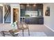 Basement with a stylish bar, comfortable seating, and stairs to the upper level at 2601 S Quebec St # 6, Denver, CO 80231