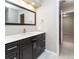 Bathroom featuring modern vanity with dark cabinetry, white countertops, and a modern mirror at 2601 S Quebec St # 6, Denver, CO 80231