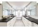 A luxurious bathroom with double vanities, marble countertops, and a standalone soaking tub at 2601 S Quebec St # 6, Denver, CO 80231