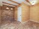 Bonus room featuring faux brick walls, tile floor and wood beam ceiling at 2601 S Quebec St # 6, Denver, CO 80231