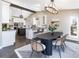 Open dining room with stylish chandelier, table with seating, connecting to the gourmet kitchen, great for entertaining at 2601 S Quebec St # 6, Denver, CO 80231