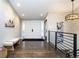 Welcoming entryway showcasing a stylish light fixture, hardwood floors, and a convenient bench for guests at 2601 S Quebec St # 6, Denver, CO 80231