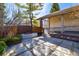 Outdoor patio featuring a built-in fire pit, stylish pavers, and lush landscaping, designed for relaxation at 2601 S Quebec St # 6, Denver, CO 80231