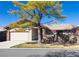 Exterior shot of a home with a two-car garage and mature trees at 2601 S Quebec St # 6, Denver, CO 80231