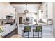 Gourmet kitchen with white cabinets, granite countertops, stainless appliances, and a large island with bar seating at 2601 S Quebec St # 6, Denver, CO 80231