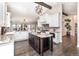 Bright kitchen featuring a large island, granite countertops, modern appliances, and an open layout at 2601 S Quebec St # 6, Denver, CO 80231
